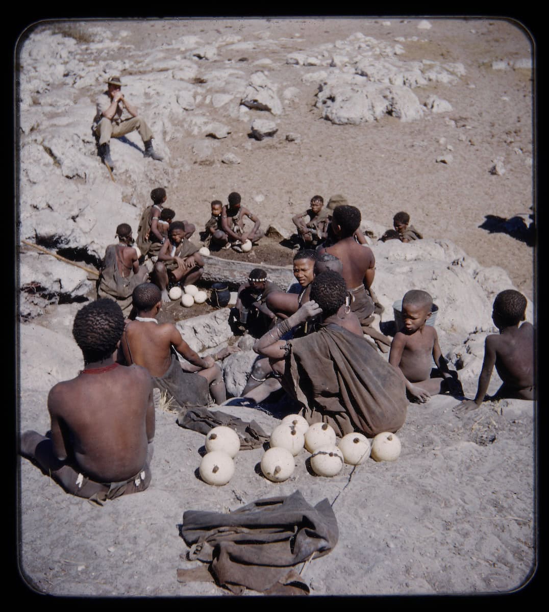 An expedition member watches the collection of water in ostrich eggshell water flasks. 1952-1953. Juǀ’hoansi. Namibia/Nyae Nyae/Tsumkwe.